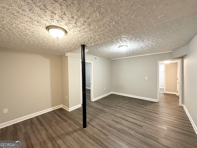 basement with dark hardwood / wood-style floors and a textured ceiling