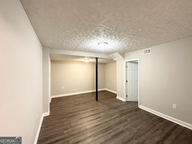 3174 Kingston Rd NW, Atlanta, GA 30318 - finished basement with dark wood-style floors and a textured ceiling
