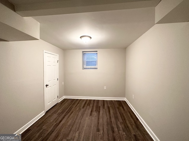 basement with dark hardwood / wood-style floors