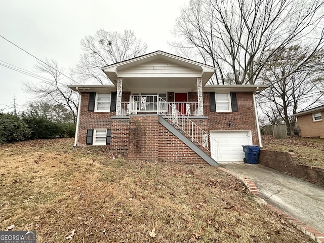 view of front of home featuring a porch, a garage, and a front lawn