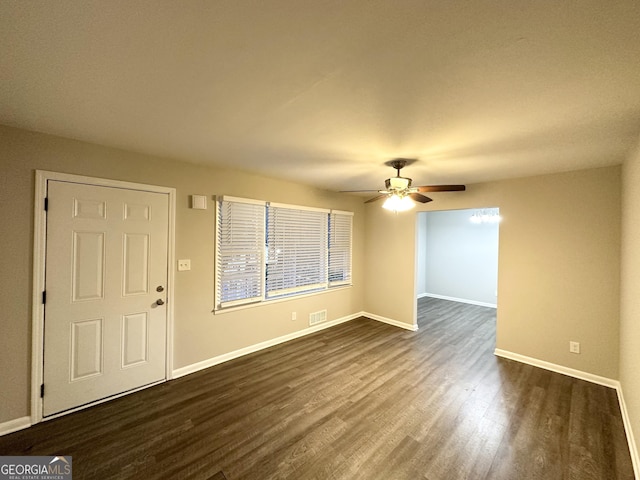 interior space with dark wood-type flooring and ceiling fan