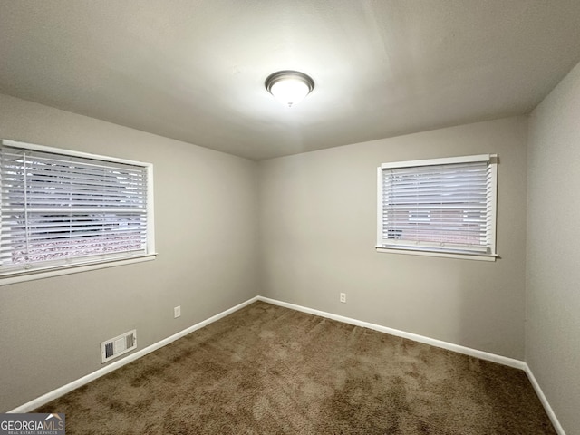 carpeted spare room with plenty of natural light