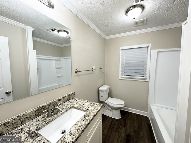 bathroom with hardwood / wood-style flooring, crown molding, vanity, a textured ceiling, and toilet