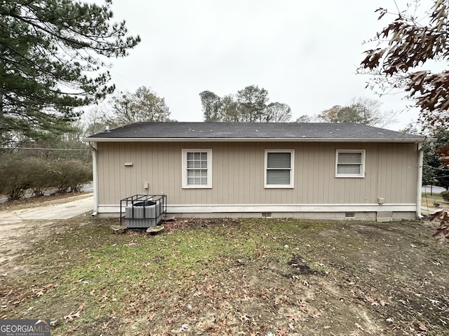 back of property featuring central AC