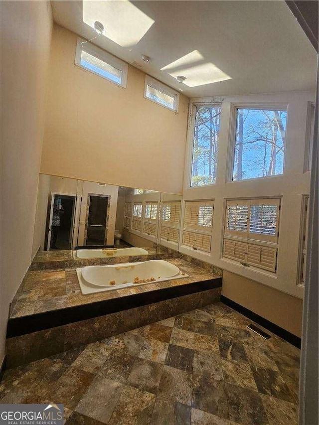 bathroom featuring a high ceiling