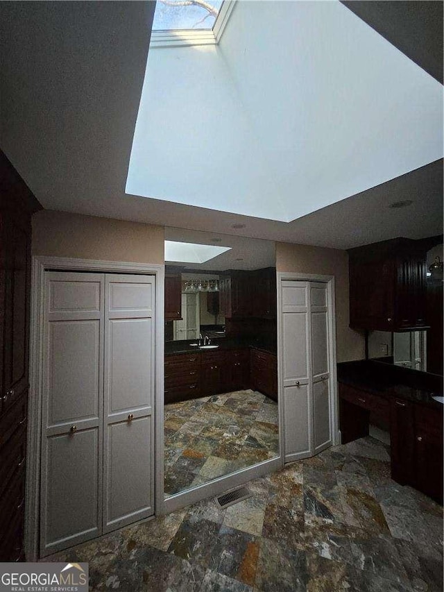 kitchen with sink and dark brown cabinets