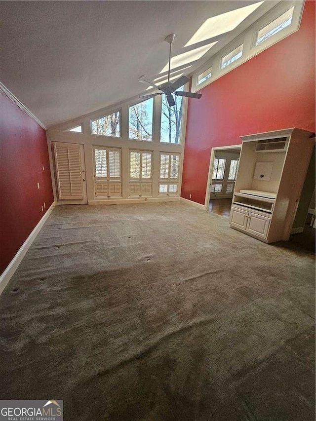 unfurnished living room featuring carpet, a textured ceiling, and high vaulted ceiling