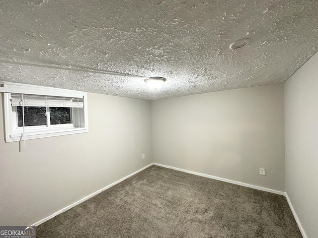 unfurnished room featuring carpet floors and a textured ceiling