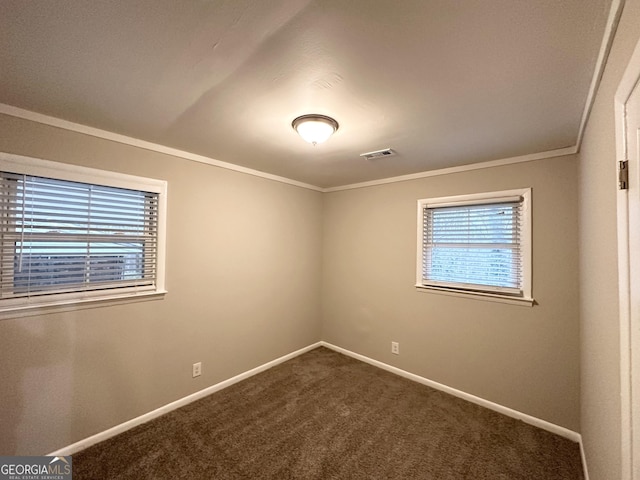 carpeted empty room featuring crown molding