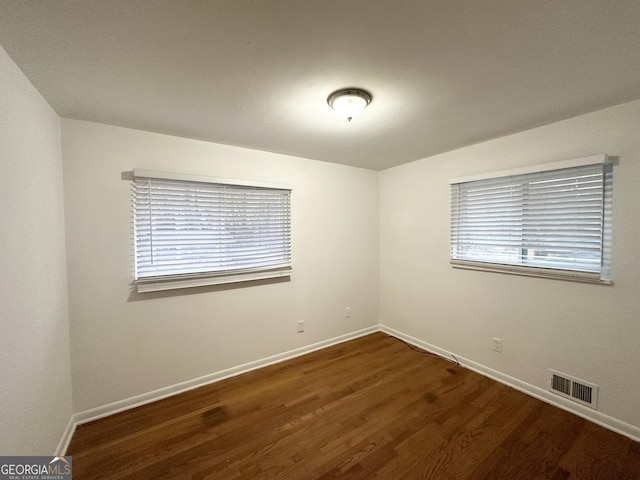 unfurnished room featuring dark hardwood / wood-style flooring