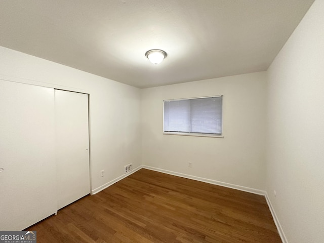 spare room with dark hardwood / wood-style flooring