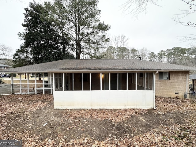 rear view of house featuring a sunroom