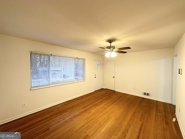 empty room with ceiling fan and hardwood / wood-style floors