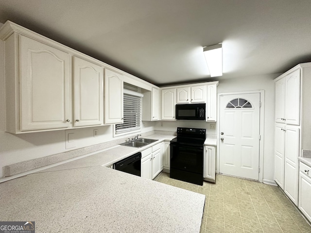 kitchen featuring white cabinetry, sink, and black appliances