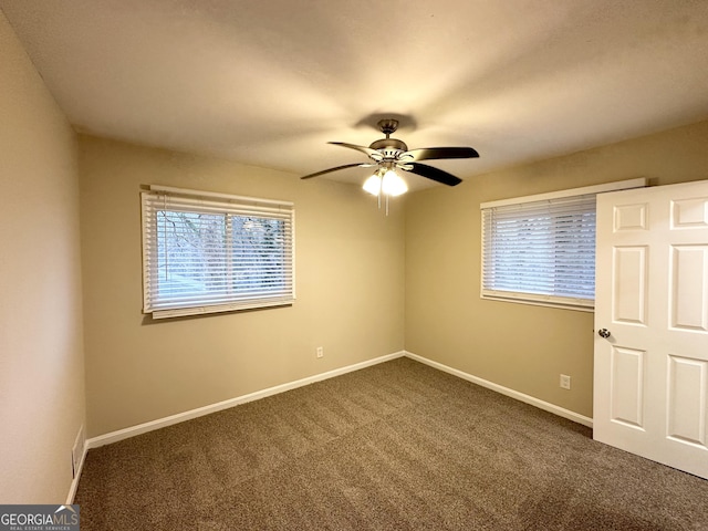 carpeted spare room featuring ceiling fan