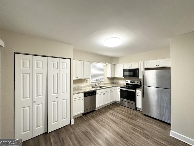 kitchen with white cabinetry, sink, dark hardwood / wood-style flooring, and appliances with stainless steel finishes