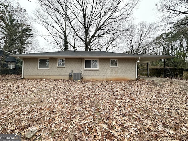 rear view of house featuring central AC and a carport