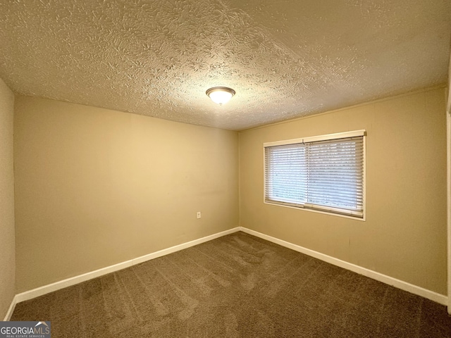 empty room featuring carpet floors and a textured ceiling