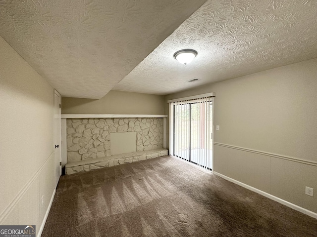 interior space with carpet flooring and a textured ceiling