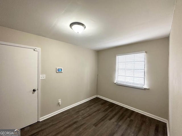 unfurnished room featuring dark hardwood / wood-style floors