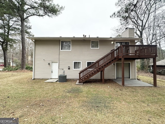 rear view of property with a patio, cooling unit, a deck, and a lawn