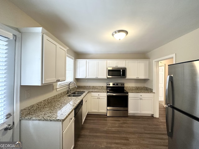 1756 Lynn Ln, Decatur, GA 30032 - kitchen with light stone counters, stainless steel appliances, sink, and white cabinets