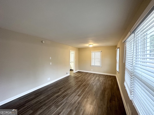 empty room with dark hardwood / wood-style floors