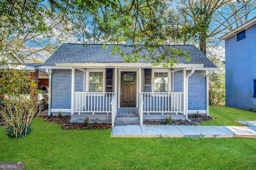 bungalow-style house with covered porch and a front lawn