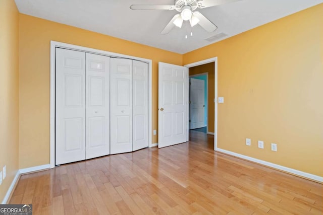 unfurnished bedroom with ceiling fan, light hardwood / wood-style floors, and a closet