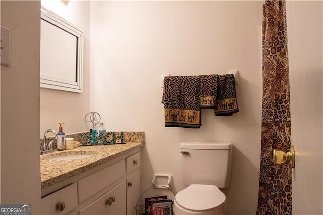 bathroom featuring toilet and vanity