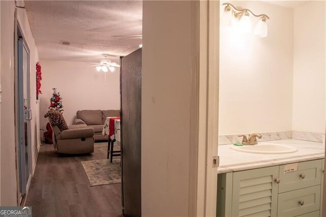 bathroom featuring vanity, toilet, and a textured ceiling