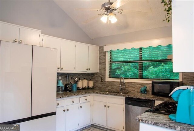 kitchen featuring tasteful backsplash, dishwasher, freestanding refrigerator, black microwave, and a sink