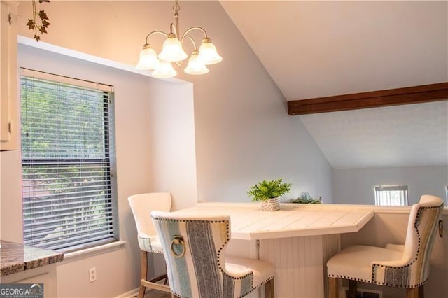 dining space featuring lofted ceiling with beams and a notable chandelier