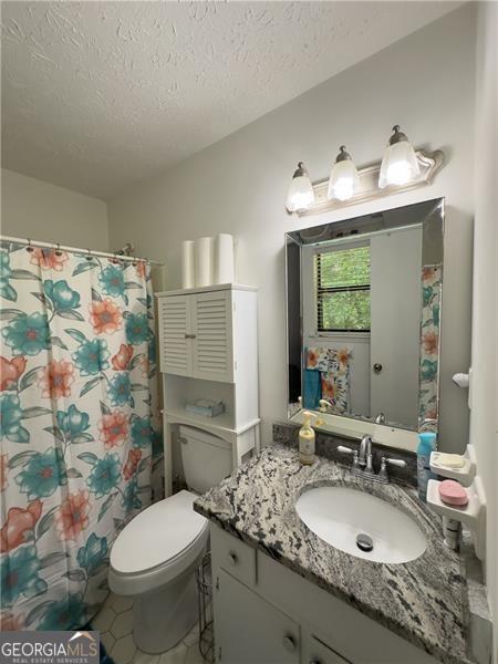 kitchen featuring white cabinetry, backsplash, decorative light fixtures, and appliances with stainless steel finishes