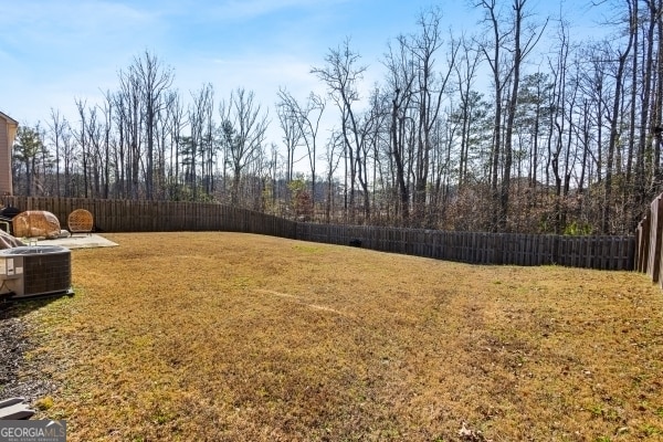 view of yard with central AC unit