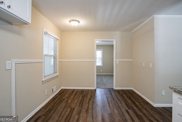 unfurnished dining area featuring dark hardwood / wood-style flooring