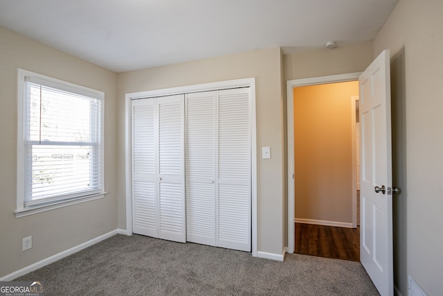 unfurnished bedroom featuring a closet and carpet flooring