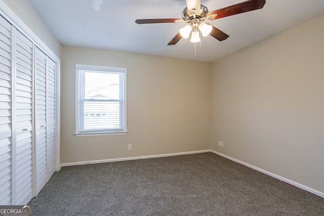 unfurnished bedroom with a closet, ceiling fan, and dark colored carpet