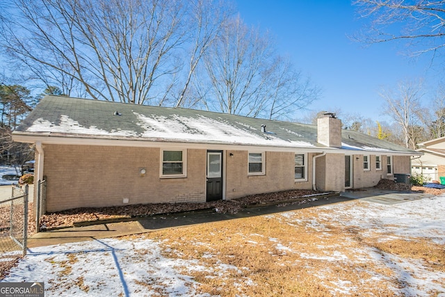 view of snow covered rear of property