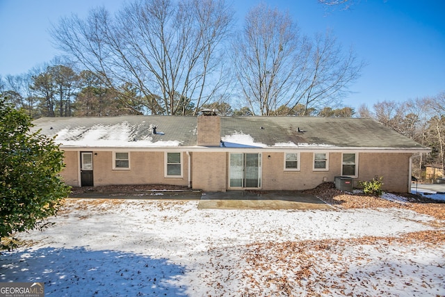 snow covered property featuring a patio and cooling unit