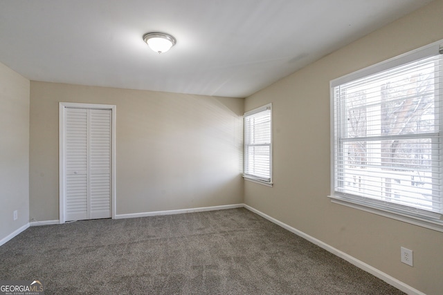 unfurnished bedroom with carpet and a closet