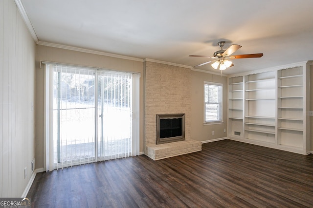 unfurnished living room featuring a fireplace, crown molding, plenty of natural light, and dark hardwood / wood-style floors