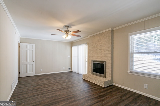 unfurnished living room with crown molding, dark wood-type flooring, ceiling fan, and a fireplace