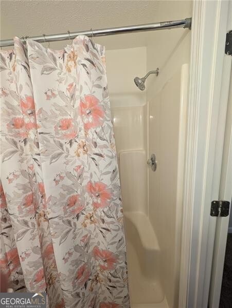 bathroom with a shower with curtain