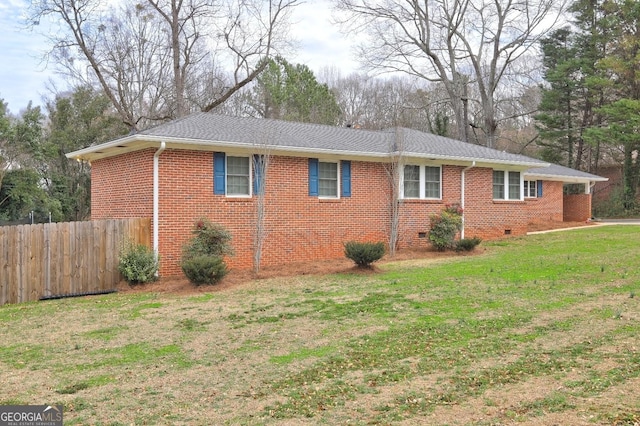 view of side of home with a lawn