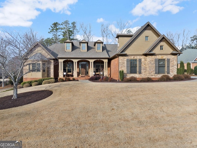 view of front of property with a front yard and covered porch