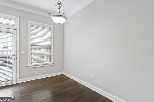 empty room with ornamental molding and dark hardwood / wood-style flooring