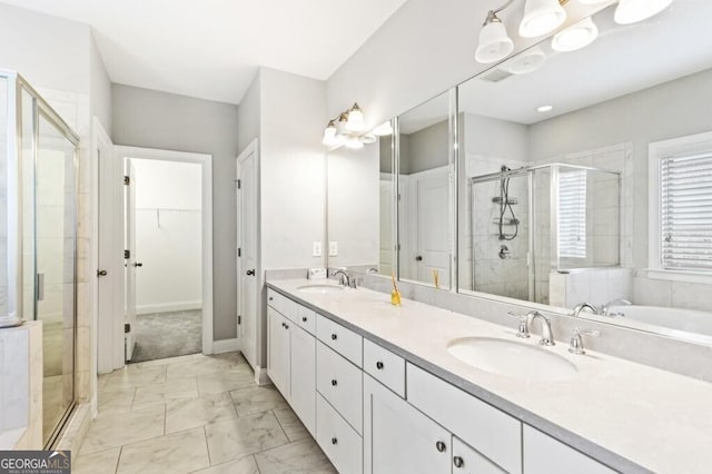 bathroom with a shower with door and vanity