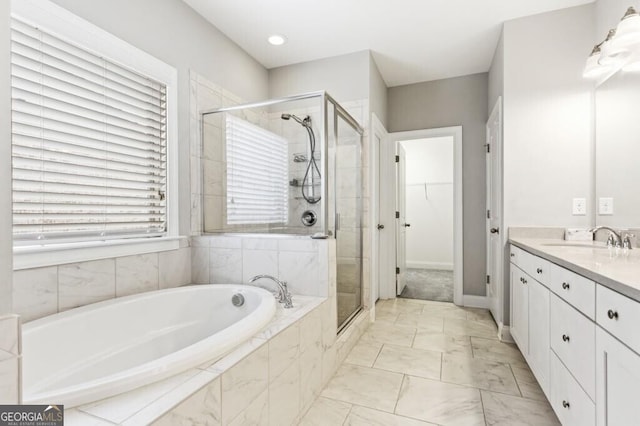 bathroom featuring vanity and separate shower and tub