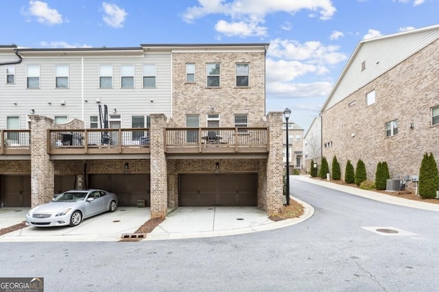 exterior space with a garage and central air condition unit